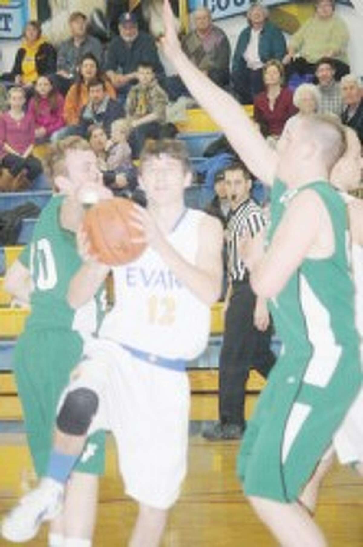 ACTION: Evart’s Kameron VanScoyoc (12) goes to the basket against Pine River. (Herald Review/John Raffel)