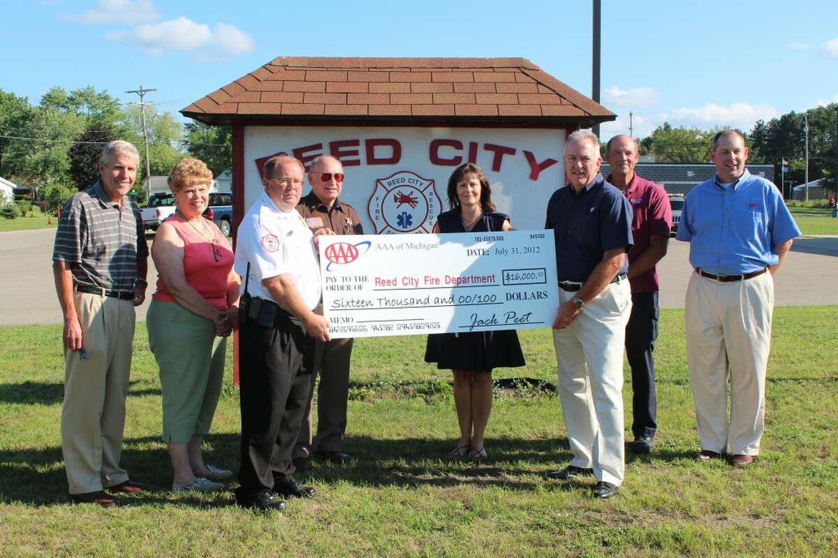 NEW EQUIPMENT: The Reed City Fire Department accepts a $16,000 grant from AAA for new rescue tools. Pictured (from left to right) is Ron Marek, Reed City city manager; Marlene Fatum, Reed City councilwoman; Dave Belden, assistant fire chief; Jim Crawford, Osceola County Sheriff; Darlene Fuller, Reed City councilwoman; Jack Peet, AAA northern region traffic safety manager; Chuck Davis, Reed City police chief and David VanderWeele, AAA field sales manager.