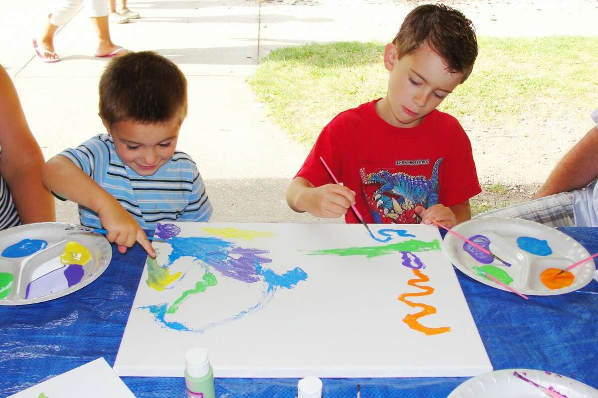 IMPROVING ARTISTIC SKILL: Brothers Tristin, 6, and Braedan, 4 collaborate to create a colorful acrylic painting. (Shannon Hartley photo/Herald Review)