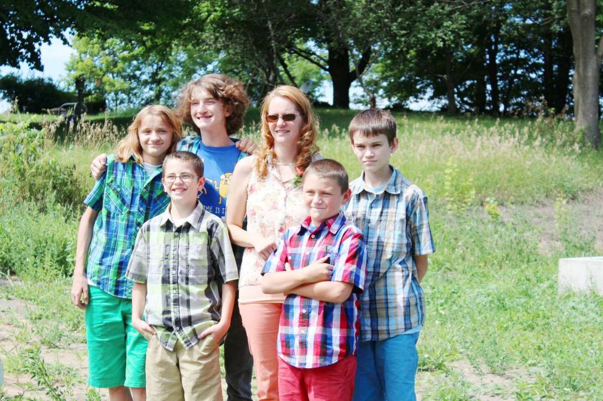 BUILDING A HOME: Marcy Jo Scott and her five sons, Jacob, 17, Kyle, 14, RJ, 13, Ryan, 12, and Chad, 10, are the recipients of the newest Osceola County Habitat for Humanity home that will be built in Reed City. A groundbreaking ceremony took place on Thursday. (Herald Review photo/Karin Armbruster)