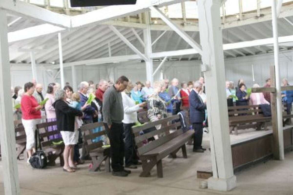COMMUNITY GATHERING: Around 100 people gathered in the tabernacle at Albright Campground Sunday for a community worship service. (Courtesy photo)
