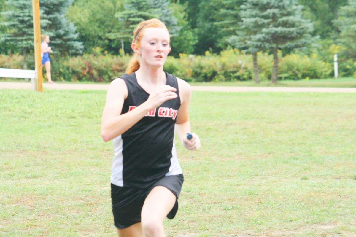 Lindsey Greer of Reed City crosses the finish line last Friday against Evart. (Herald Review photo/John Raffel)