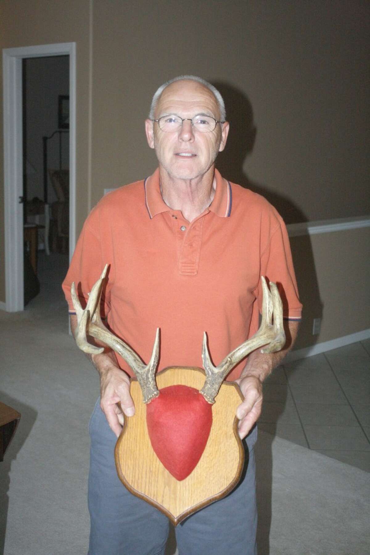 TROPHY BUCK: Reed City's George Vasicek shows the rack of a trophy buck he has shot during his hunting career. (Herald Review photo/John Raffel)