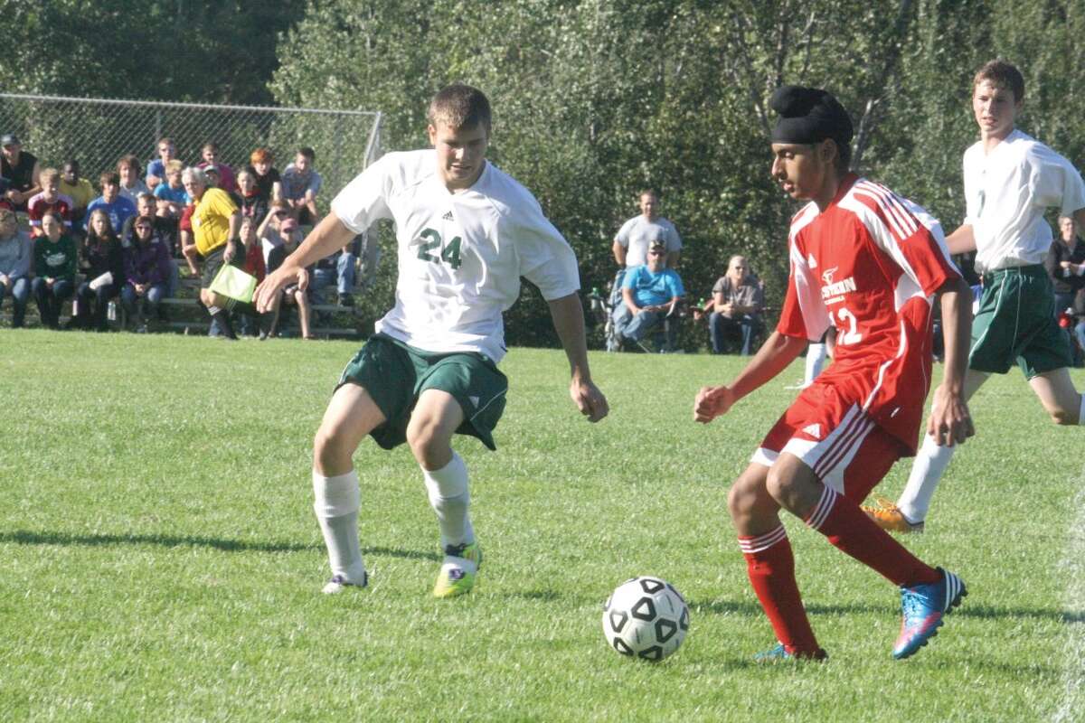 TOUGH DEFENSE: Larry Kissinger (24) of Pine River soccer goes after the ball against Mason County Eastern. (Herald Review photo/John Raffel)