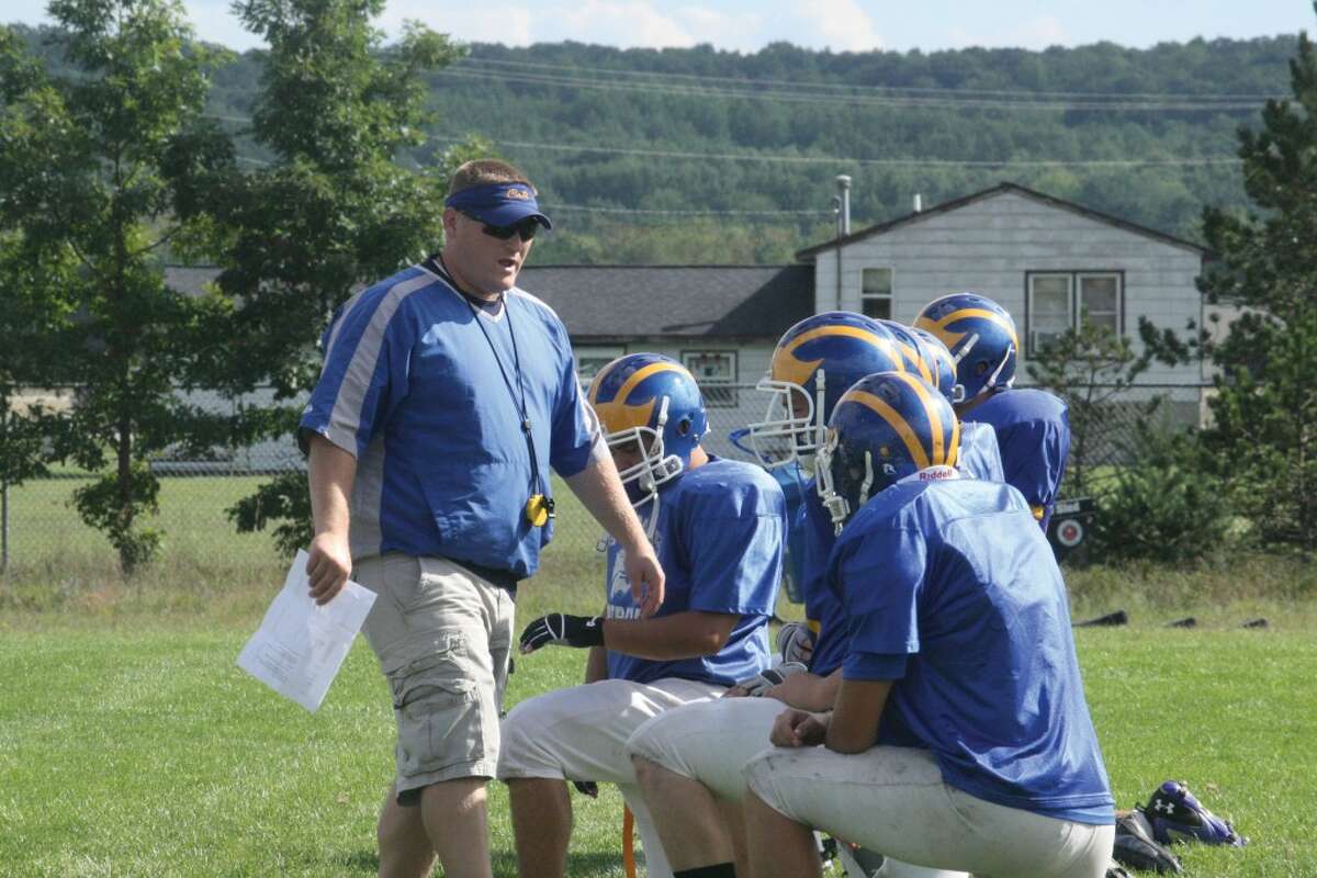 BACK TO WORK: Pat Craven, Evart football coach, talks strategy with his players at a Monday practice. (Herald Review photo/John Raffel)