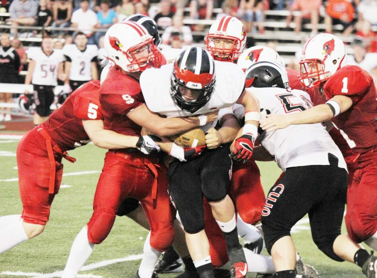 GANGING UP: Reed City running back Garrett Benson is wrapped up by several Big Rapids players during Friday's high school football action. Reed City won the game, 14-6. (Pioneer photo/Bob Allan)