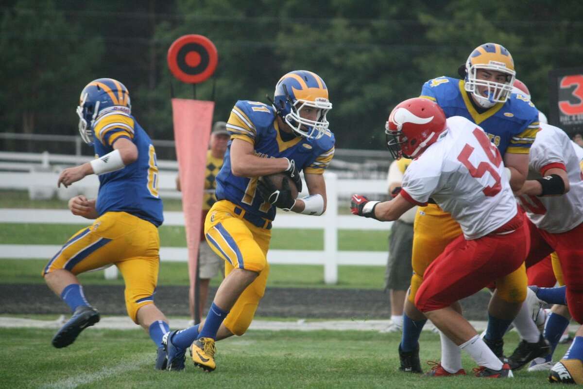 FULL SPEED AHEAD: Evart takes the ball down the field against Suttons Bay during high school football action on Friday. (Pioneer photo/John Raffel)