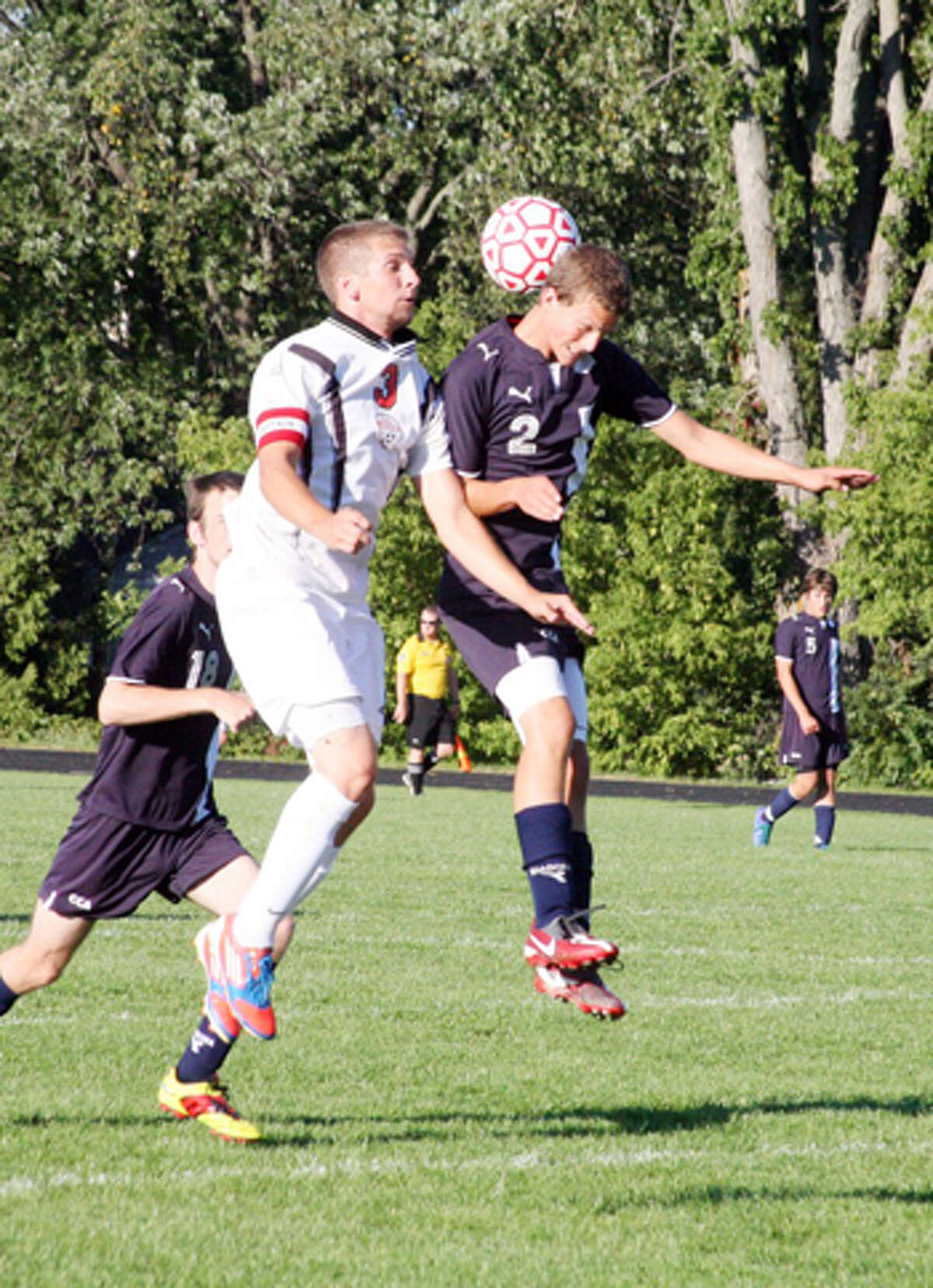 HEADS UP: Reed City's Ricky Droke goes up for a header against CCA's Justin Thorne. (Herald Review photo/John Raffel)