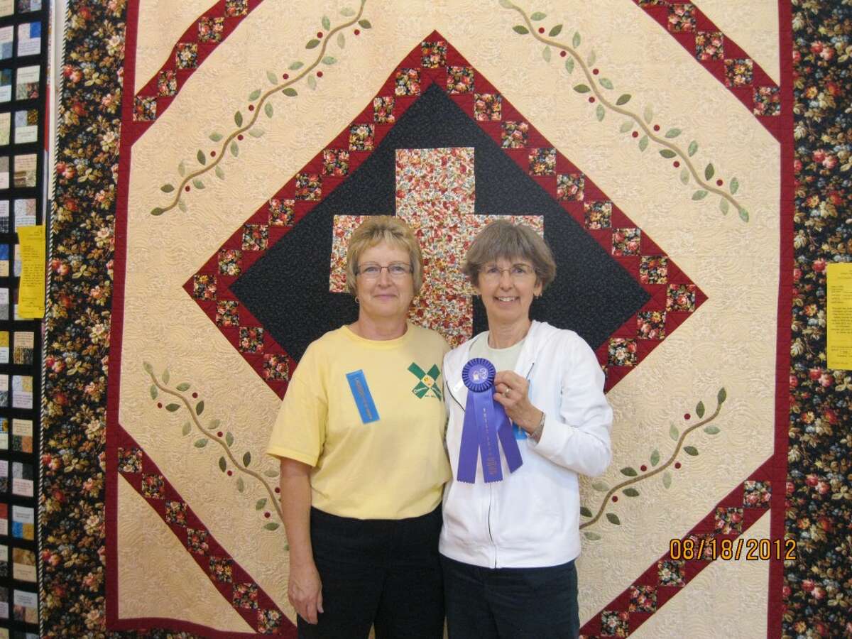 QUILT OF HOPE: Nancy Sage (right) tied for Best of Show with her “Quilt of Hope.” Pictured is Sage and quilt maker Deb Sweet, who gave the quilt to Sage as a retirement gift.