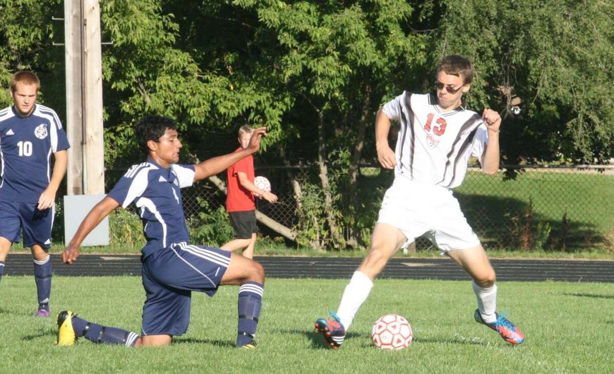 SCRAPPING: Big Rapids' Shawn Heroor (left) looks to get the ball away from a Reed City player on Tuesday. (Herald Review photo/John Raffel)