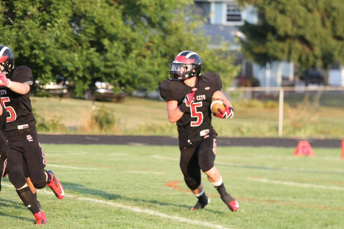 BREAKING OUT: Garrett Benson (5) of Reed City looks for running room against Morley Stanwood. (Pioneer photo/Bob Allan)