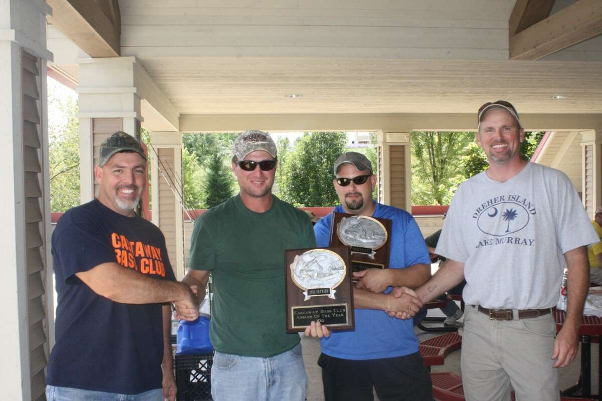 MASTER ANGLERS: Mitch Harrell, far left, and Tim Johns, far right, of the Castaways Bass Fishing Club in Mecosta County, award Jake Erickson (second from left) and Derrick Ransom as Anglers of the Year. (Herald Review photo/John Raffel)