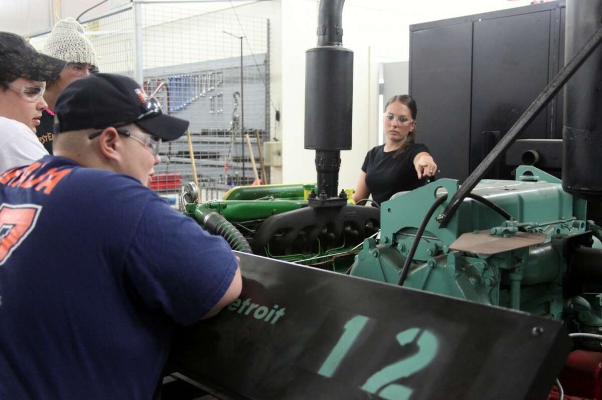 DIESEL TECHNOLOGY: Instructor Toni Valley (right) asks her students at the Mecosta-Osceola Career Center to review the work they did last year. Valley is one of four new instructors at the MOCC this year. (Herald Review photos/Lauren Fitch)