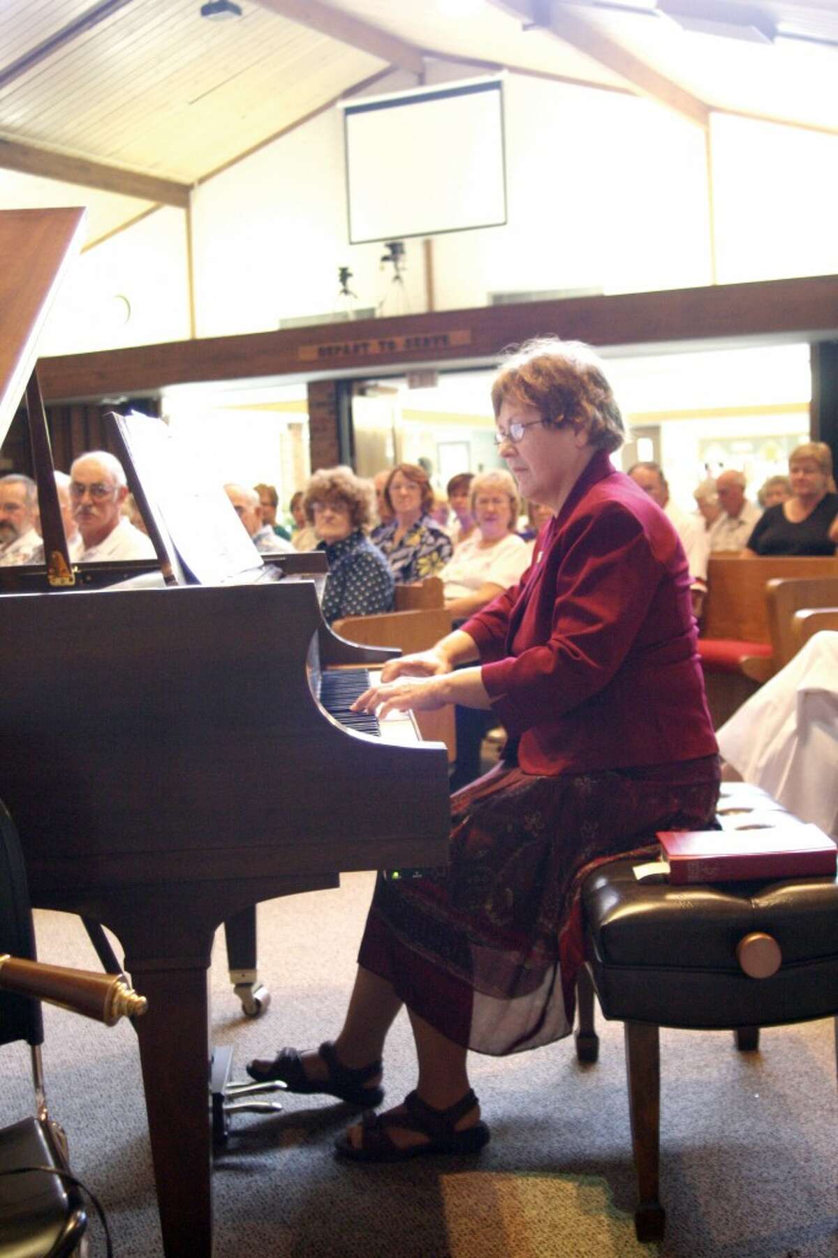 MUSICAL CELEBRATION: Lois Hinkins Stilber, a member of the Rev. George Bennard's family, plays a song for the audience at the Old Rugged Cross Centennial Celebration on Aug. 10. (Courtesy photo/Dianne Phelps)