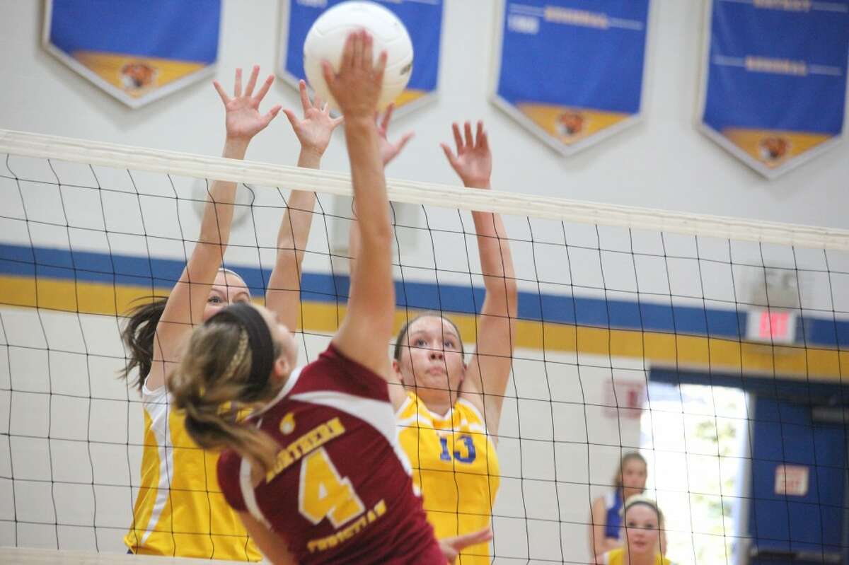 DOUBLE TEAM: Evart's Kirsten Parsons and Jessica Tea attempt to block a shot by McBain Northern Michigan Christian on Tuesday. (Herald Review photo/Martin Slagter)