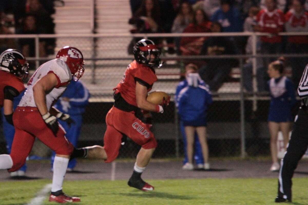 TO THE HOUSE: Reed City's Garrett Benson picks up a fumble and returns it for a touchdown during Friday's football game with Chippewa Hills. (Pioneer photo/Justin McKee)