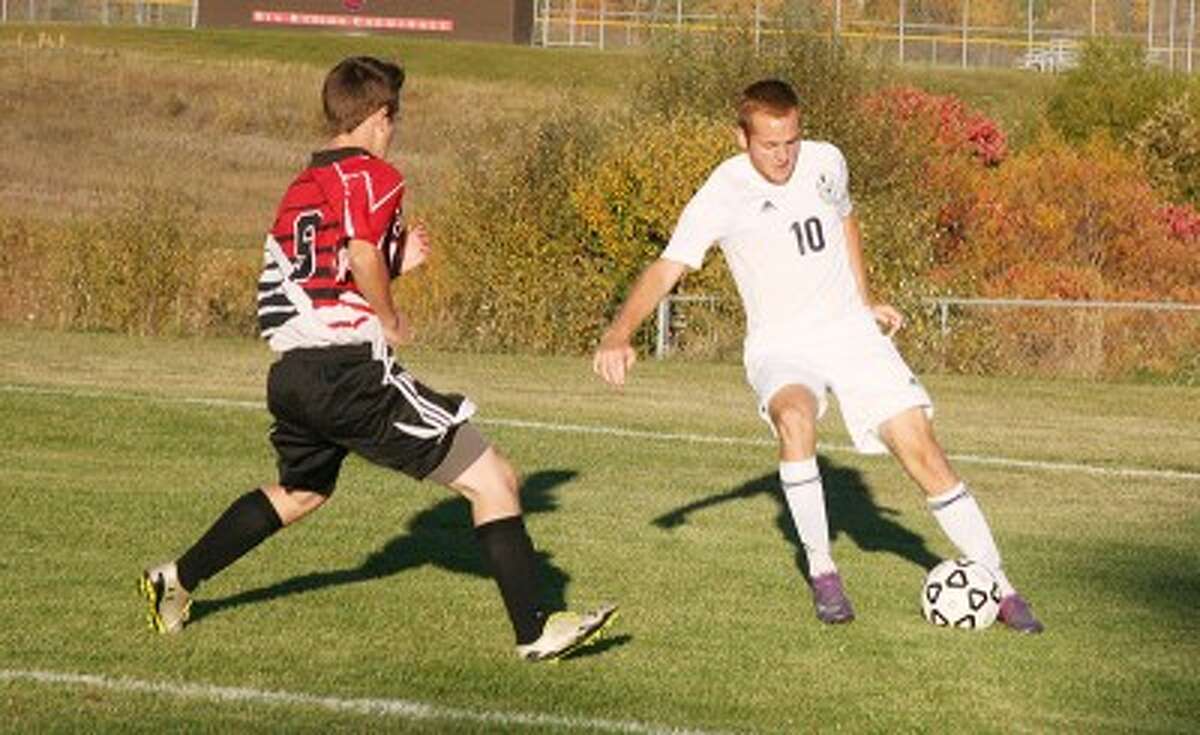 FOCUS: Big Rapids' Andrew Klarecki looks to make a move on a Reed City defender during the Cardinals' 6-0 win on Tuesday. (Herald Review photo/Martin Slagter)