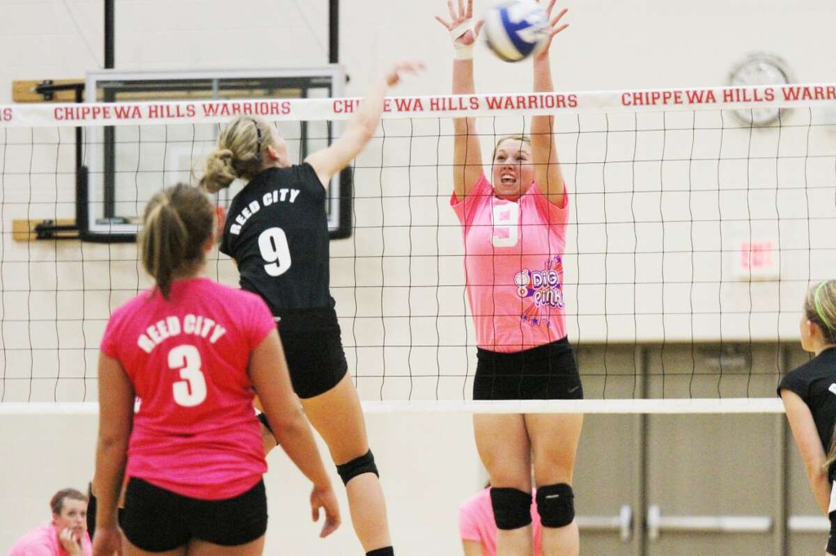 ON THE MOVE: Chippewa Hills' Olivia Wolfe (right) goes up for the block on an attack of Reed City's Natalie Westhoff during Wednesday's contest. (Herald Review photo/Bob Allan)