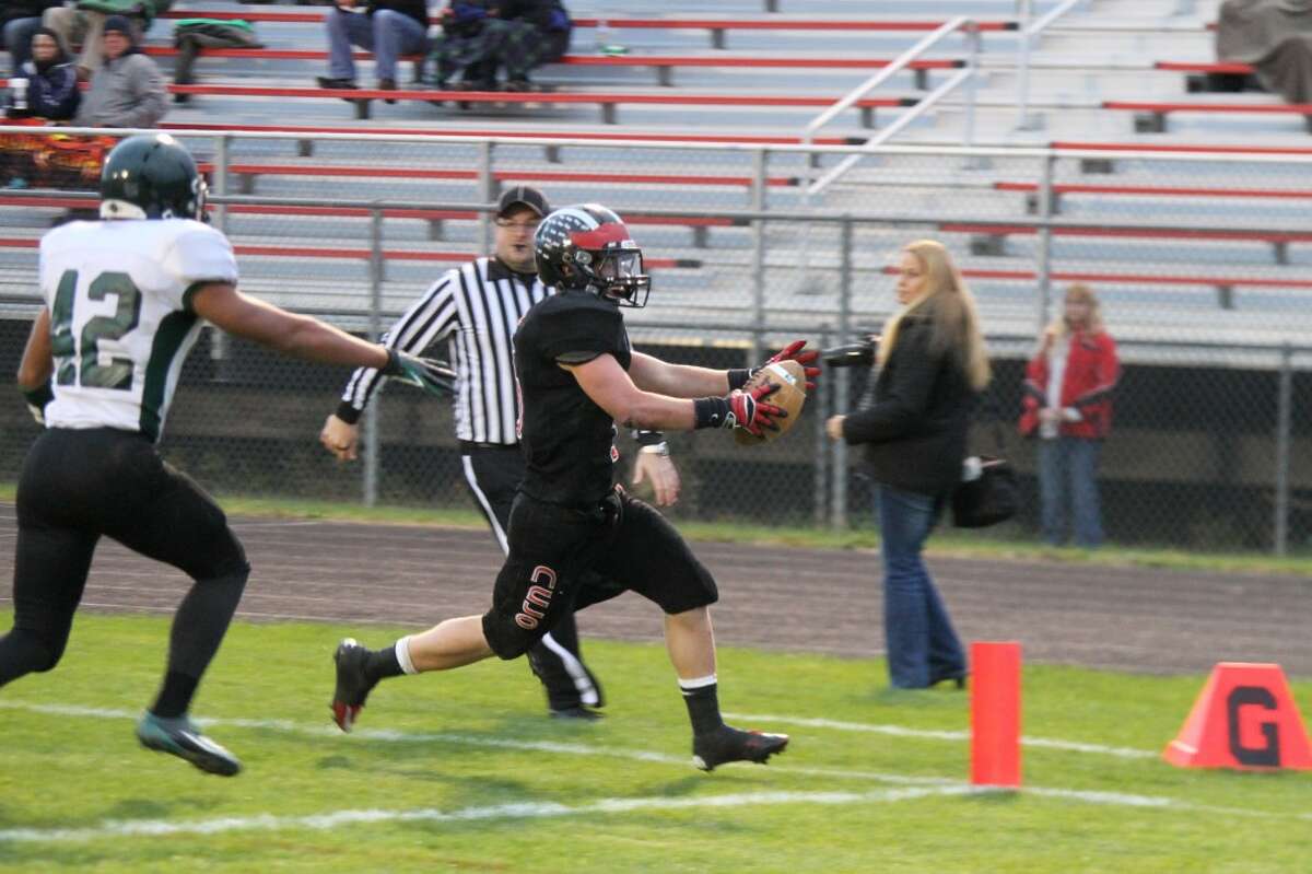 TOUCHDOWN: Reed City's Garrett Benson extends his arms for another touchdown against Hesperia on Friday. (Herald Review photo/Martin Slagter)