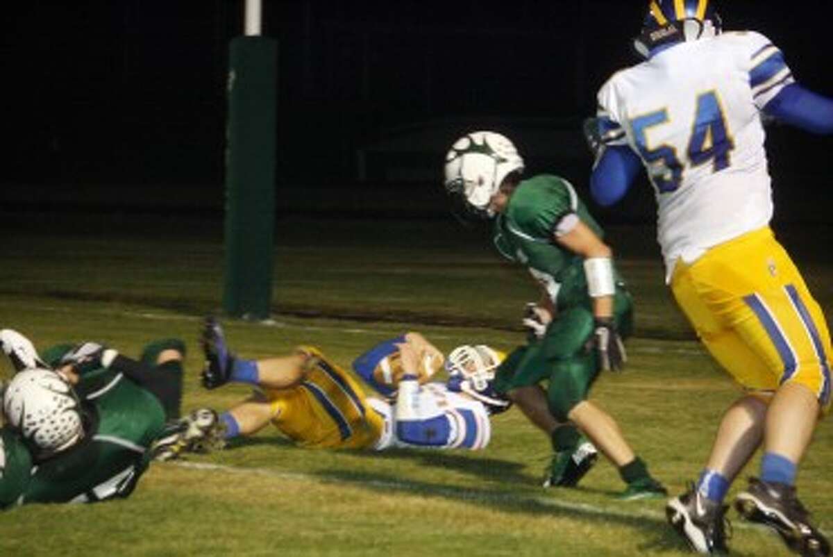 DEFENSE OF STEEL: Pine River players go after the running back during recent action. (File photo)