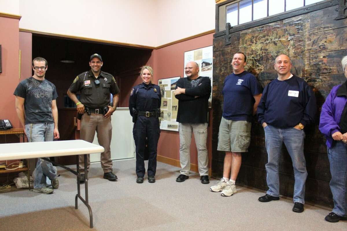 COMMUNICATION ACTIVITY: Evart community members line up in order of age without talking or using their hands. The activity was used to raise awareness of the need for communication in problem solving, as it relates to the community's new Neighborhood Watch program. (Herald Review photo/Sarah Neubecker)