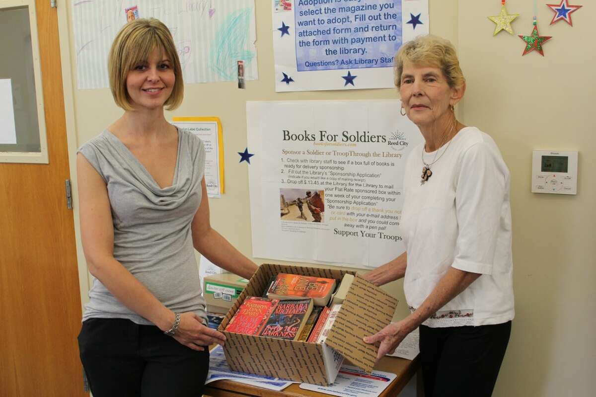 SENDING BOOKS: The Reed City Library accepts sponsors for two boxes of books to be sent to soldiers each month. To date, the library has sent 10 boxes overseas through the Books for Soldiers program. (Herald Review photo/Sarah Neubecker)