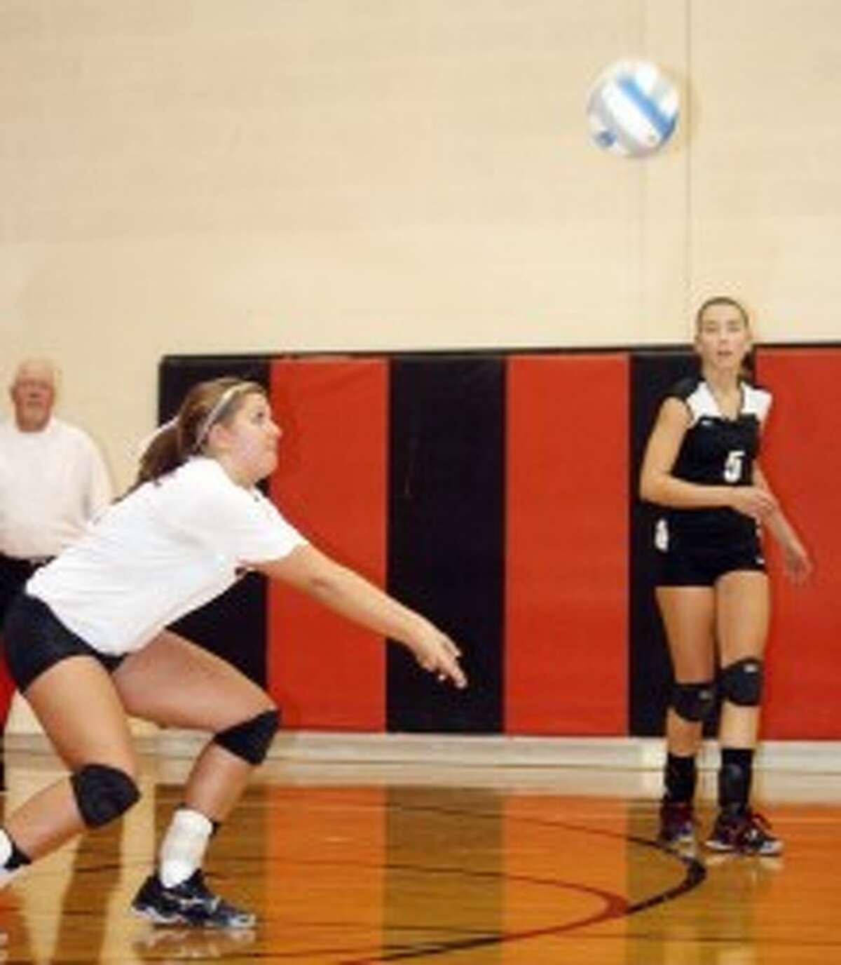 READY, SET...: Reed City volleyball's Kalee Hensel makes the pass while teammate Jacolyn Mullins watches the action. (File photo)