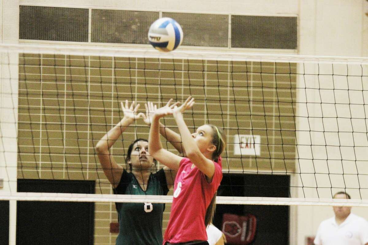 SETTING IT UP: Reed City setter Heather Tacey sets the ball to a teammate during Wednesday's volleyball action against Central Montcalm. (Herald Review photo/Bob Allan)