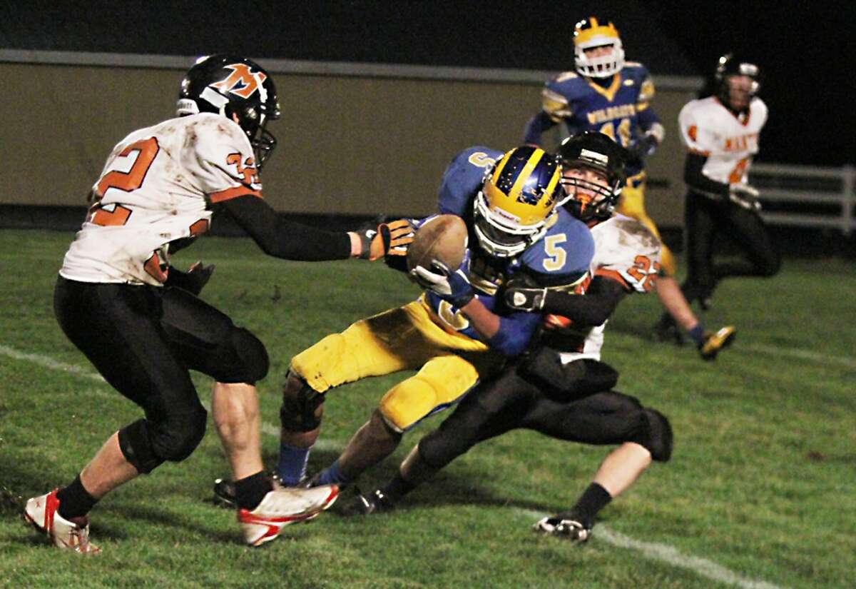 HAPPY ENDING: Evart's Chapman Long fights for extra yardage on Friday. (Herald Review photo/Bob Allan)