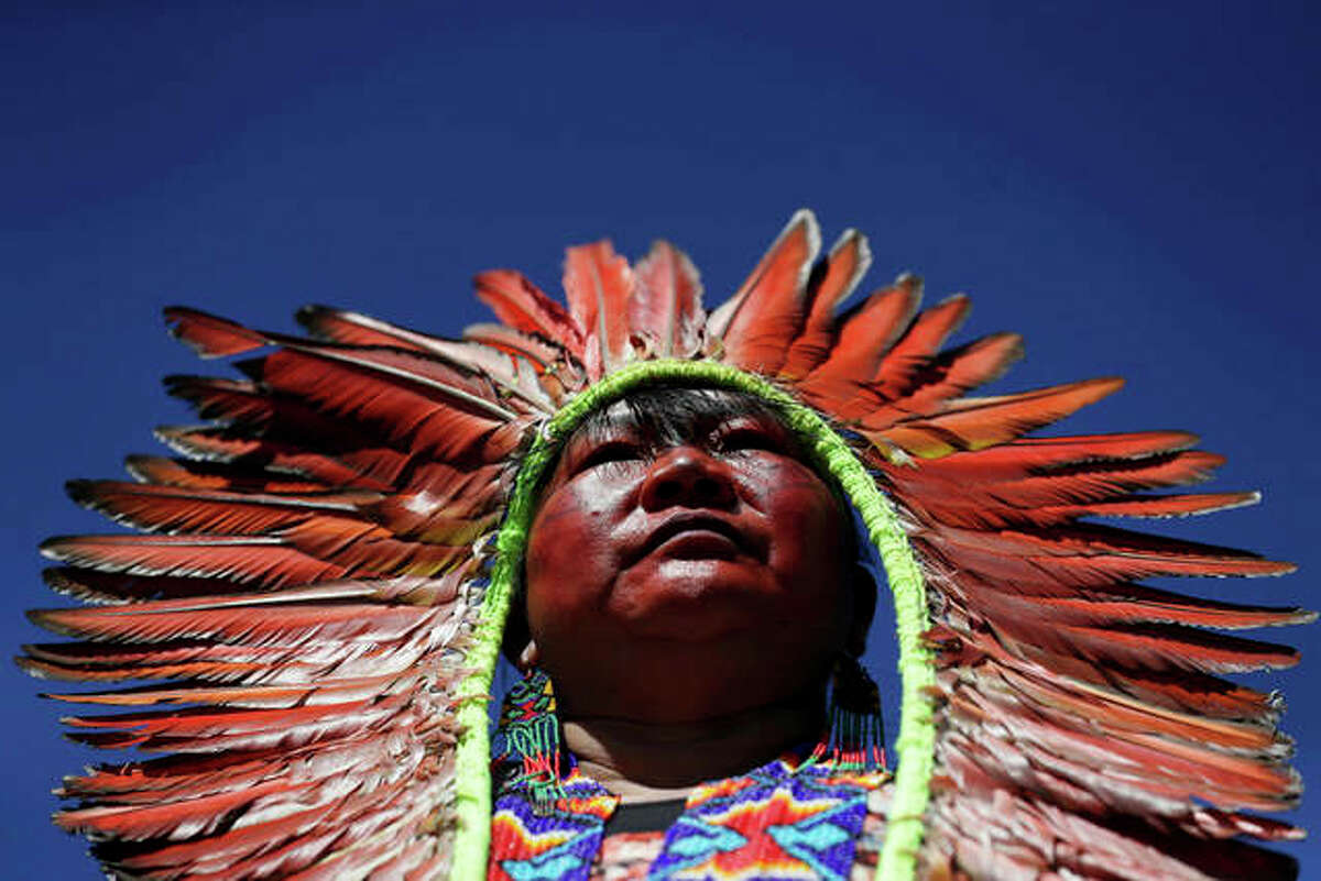 A female chief attends a march by indigenous women protesting the policies of Brazilian President Jair Bolsonaro in Brasilia, Brazil, Tuesday, Aug. 13, 2019. Since taking office in January, the Bolsonaro administration has consistently clashed with environmentalists and others over possibly opening up the Amazon rainforest to development and agribusiness. Recent data has also pointed to a surge in deforestation, which frequently occurs on indigenous reserves. (AP Photo/Eraldo Peres)