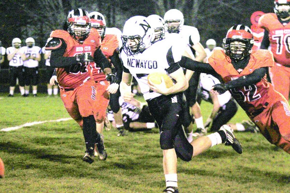 TOUGH RUN: Reed City defensive players, including Jacob Vincent (52), look to make the play against Newyago Friday night. (Herald Review photo/Bob Allan)