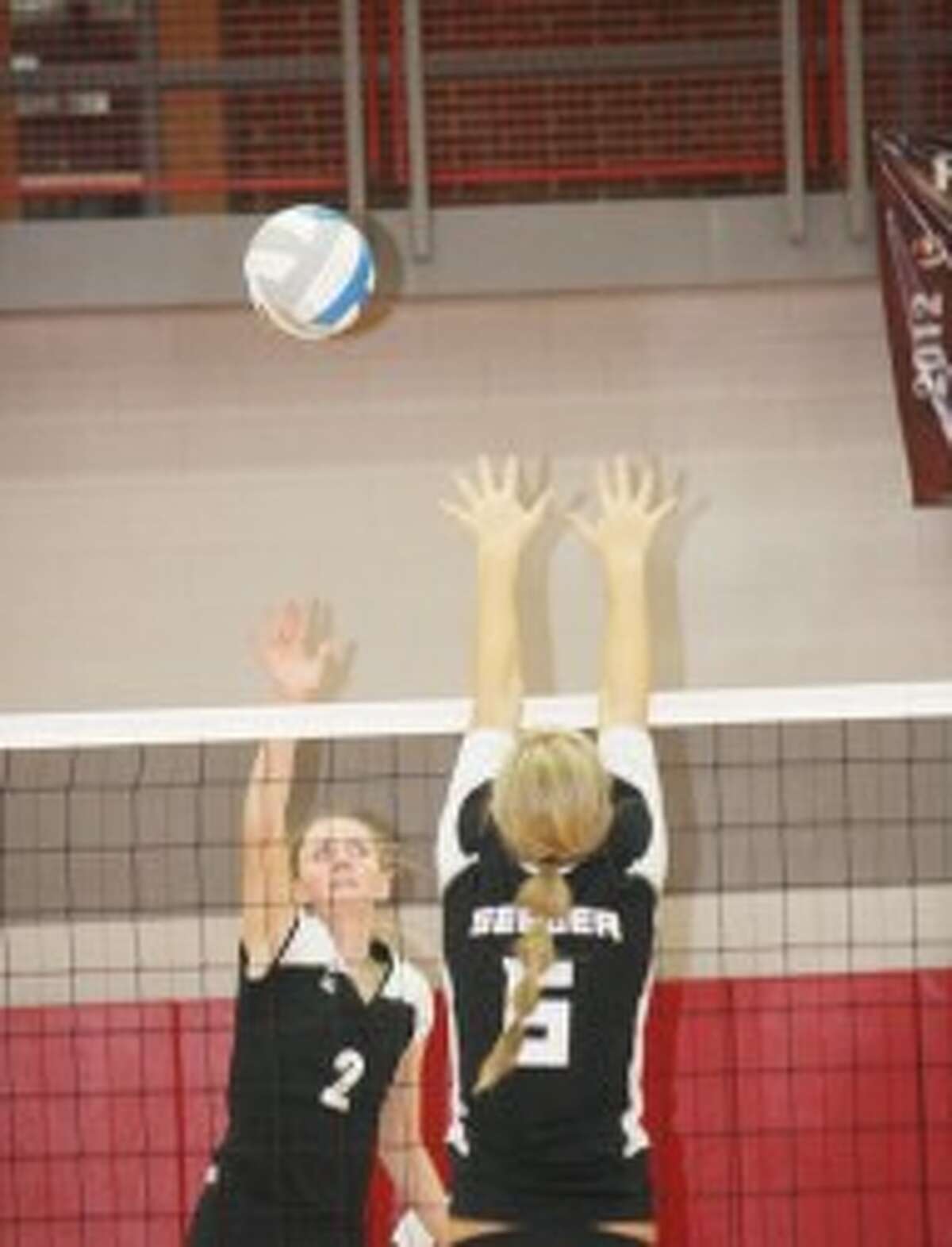 OVER THE NET: Reed City's Emma Lockhart hits a ball over the net during Thursday's regional final against Whitehall. (Pioneer photo/John Raffel)