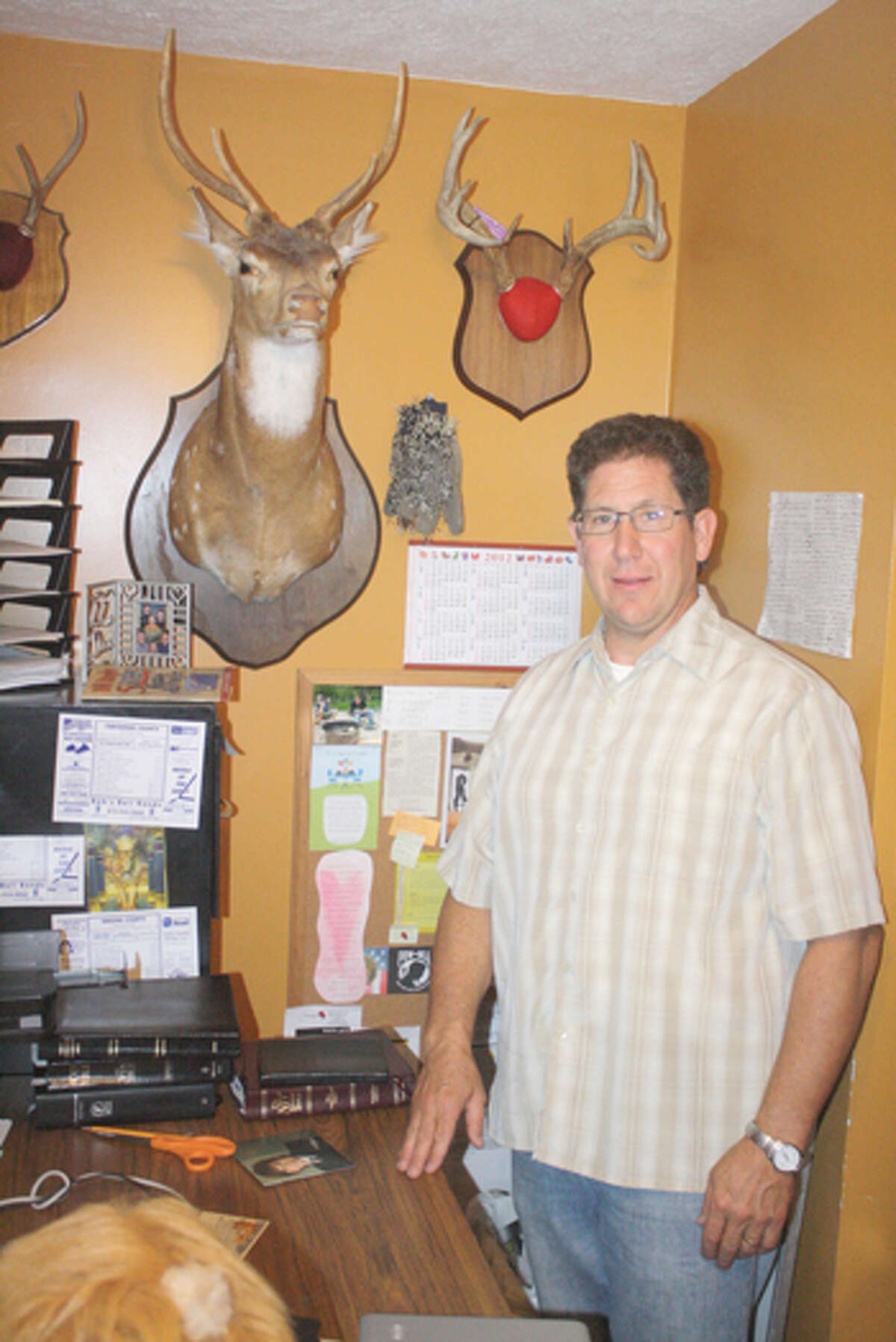 HUNTER’S PRIDE: Ryan Shrable stands in his home with displays of the various successes he's enjoyed throughout his hunting career. (Herald Review photo/John Raffel)