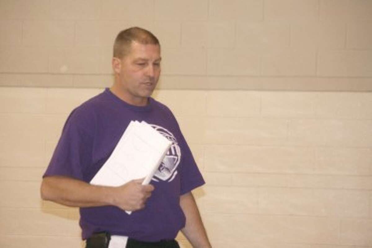PREPARATION: Reed City girls basketball coach Brian Koopman goes over details with his players at Monday's practice. (Herald Review photo/John Raffel)