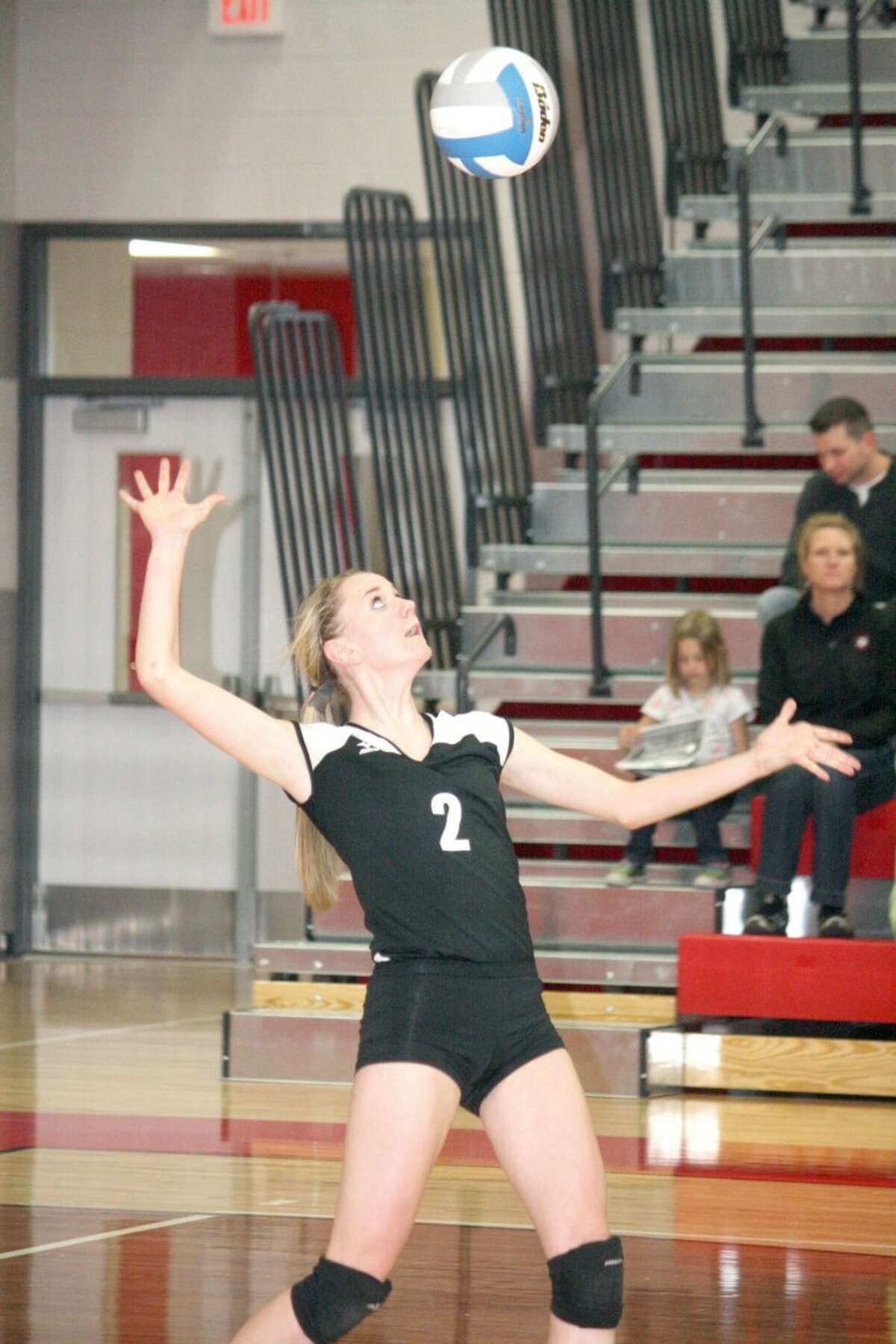 SERVE: Emma Lockhart gets ready to serve the ball for Reed City against Whitehall. (Herald Review photo/John Raffel)