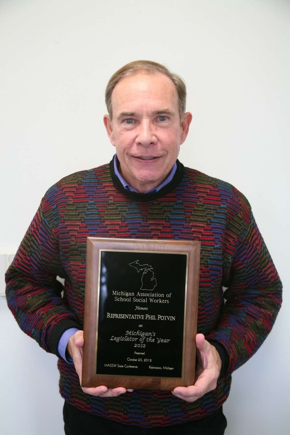 HONORED: State representative Phil Potvin receives the award for Michigan's Legislator of the Year by the Michigan Association of School Social Workers.