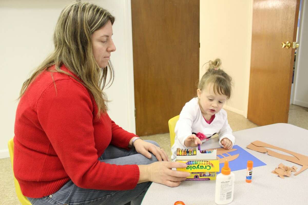 LEARNING: Henrietta DuBreuil, left, works with Tatum, 2, at the Rooted to Grow Learning Center in LeRoy. The center opened Nov. 5 and offers a place for children age 33 months to five years old to learn with curriculum in conjunction with Pine River School District. (Herald Review photo/Sarah Neubecker)