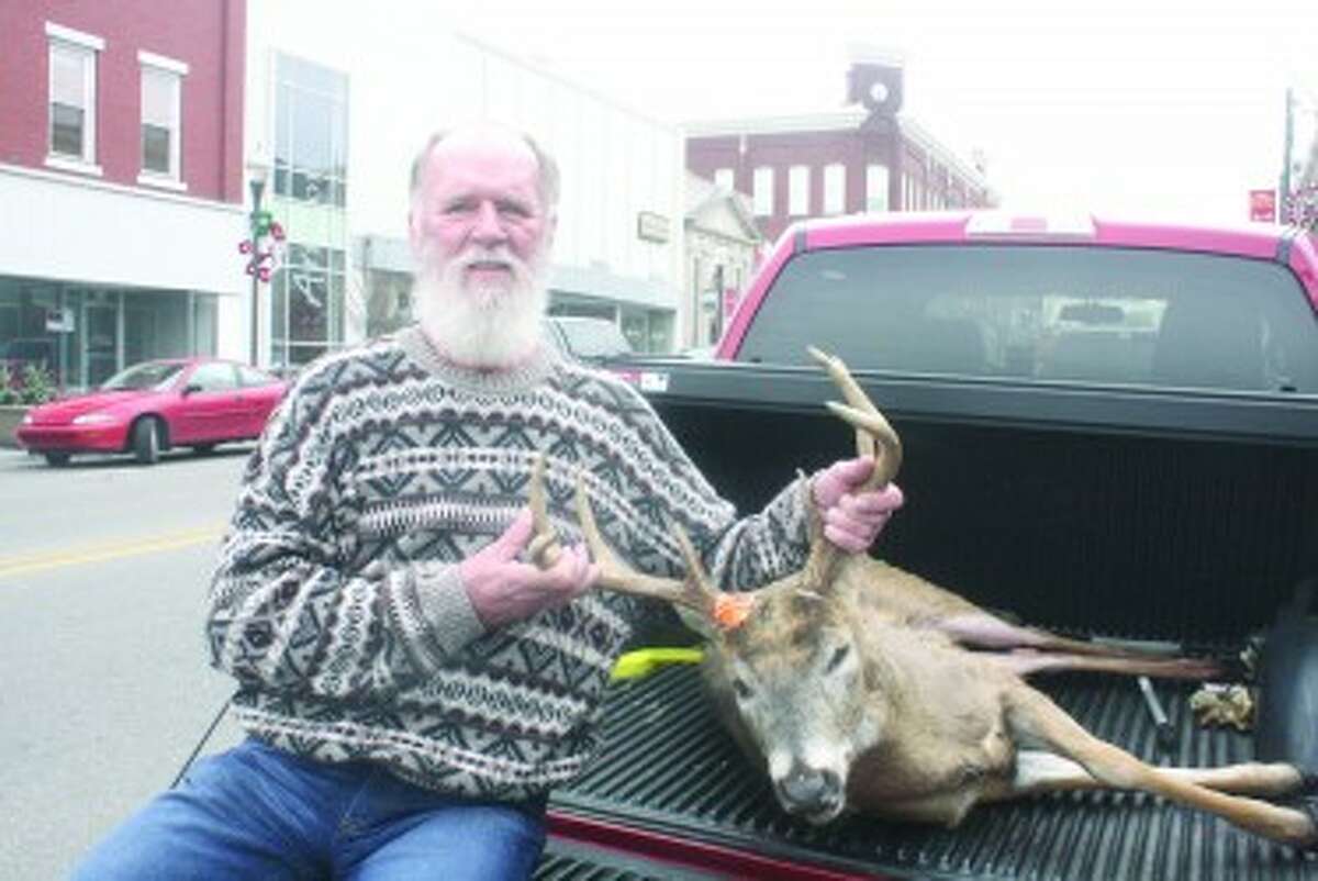 8 POINT: Bob Pinsch, 67, of Hersey, used one shot from his 30.06 to bag an 8-point buck with 16-inch rack span Saturday afternoon on his property. (Herald-Review photos/John Raffel)