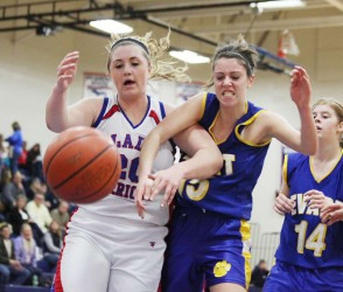 FIGHT FOR IT: Chippewa Hills' Kendall Boone battles for a loose ball with Evart's Mara VanOrder on Friday. (Pioneer photo/Bob Allan)
