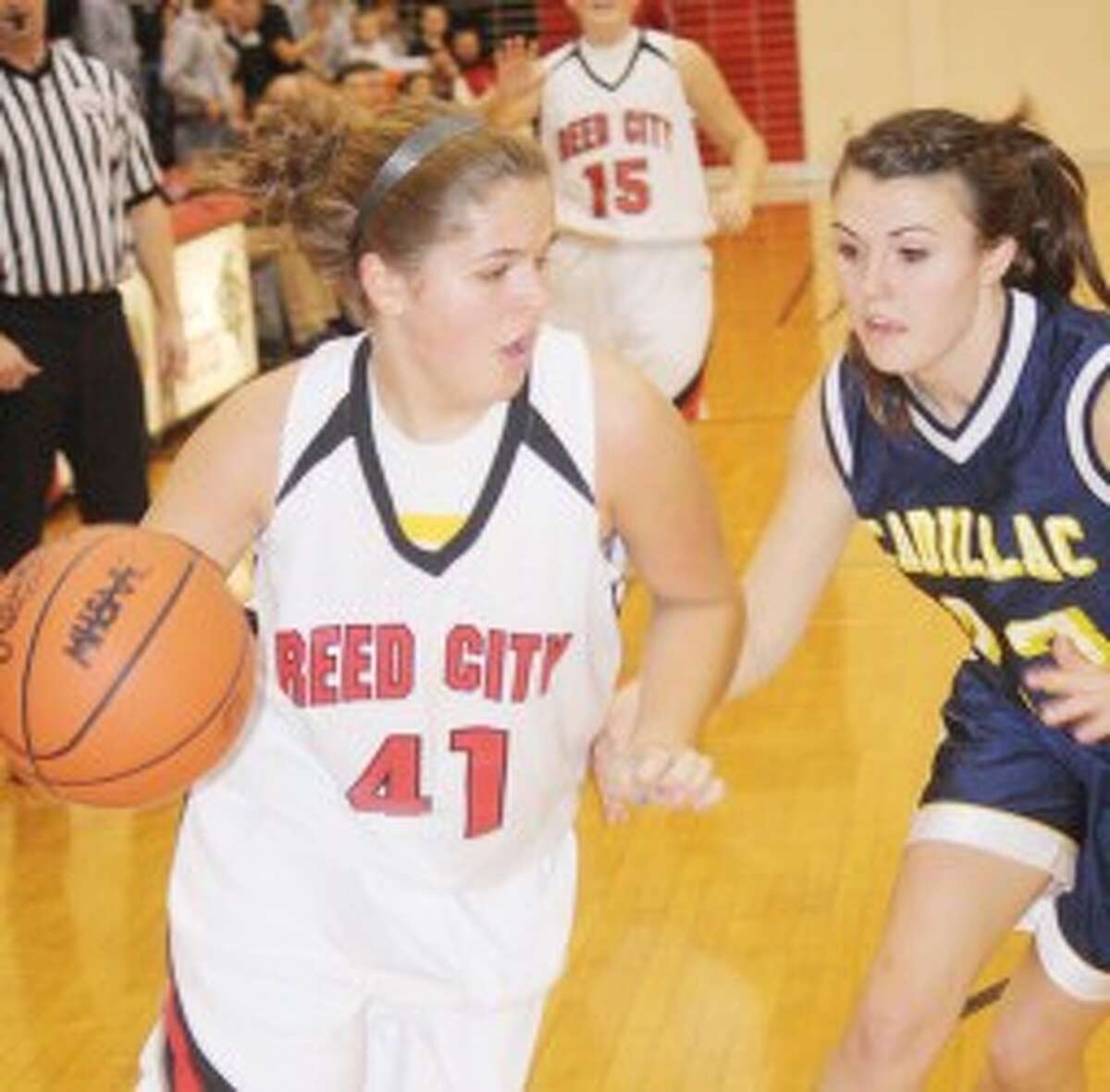 DRIVING: Reed City's Karah Hensel looks to drive to the basket during Friday's high school basketball action against Cadillac. (Pioneer photo/John Raffel)