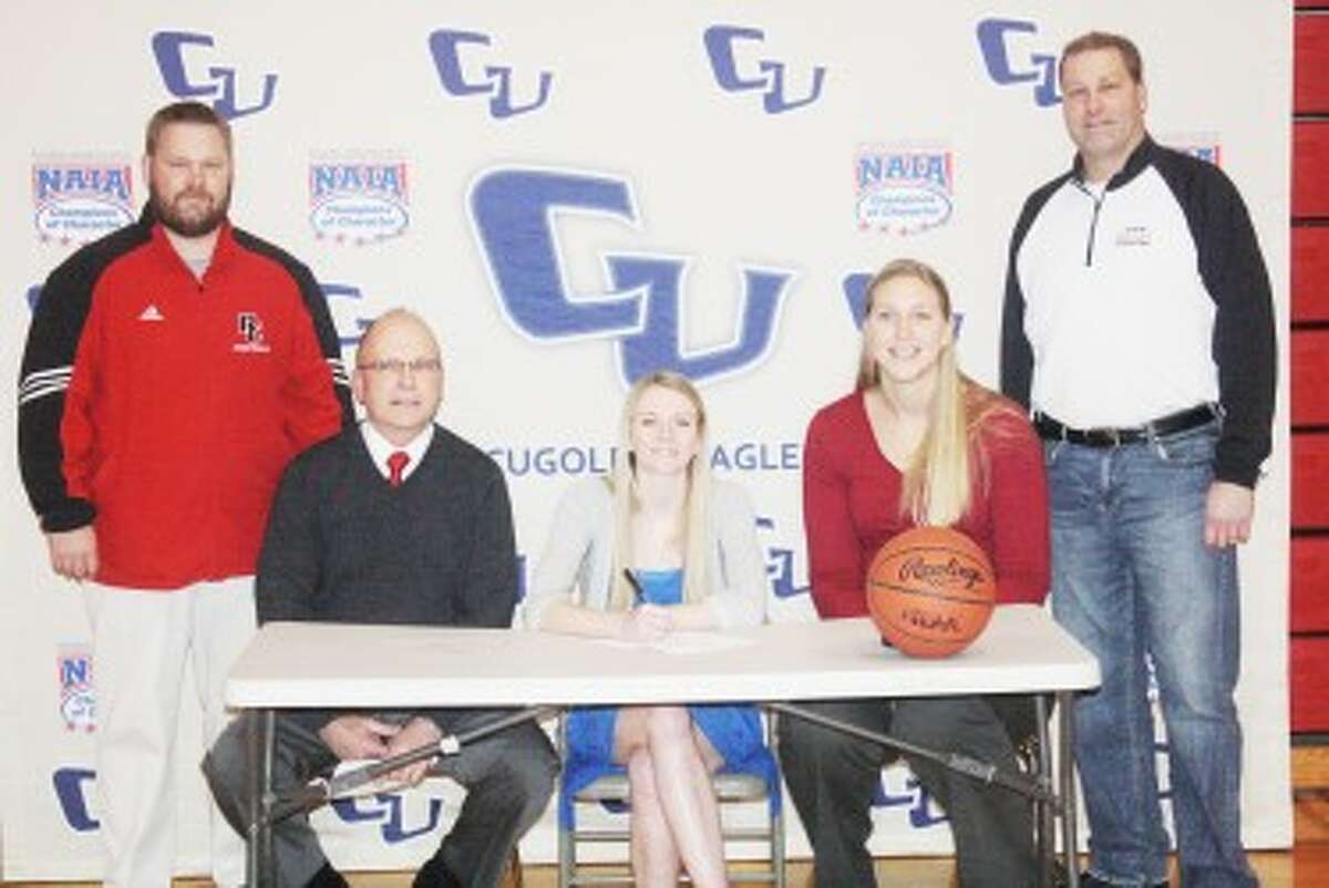 SIGNING: Emma Lockhart signs her letter-of-intent with athletic director Monty Price, girls basketball assistant coach Tim Webster, Cornerstone coach Katie Mattera and Reed City girls basketball coach Brian Koopman. (Pioneer photo/John Raffel)