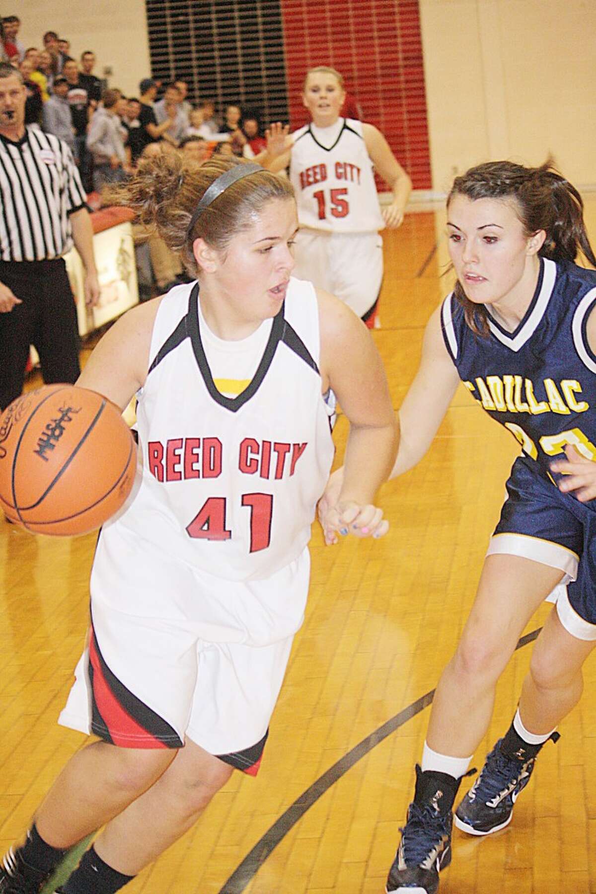 PUSHING FORWARD: Karah Hensel of Reed City drives to the basket against Reed City. (Pioneer photo/John Raffel)