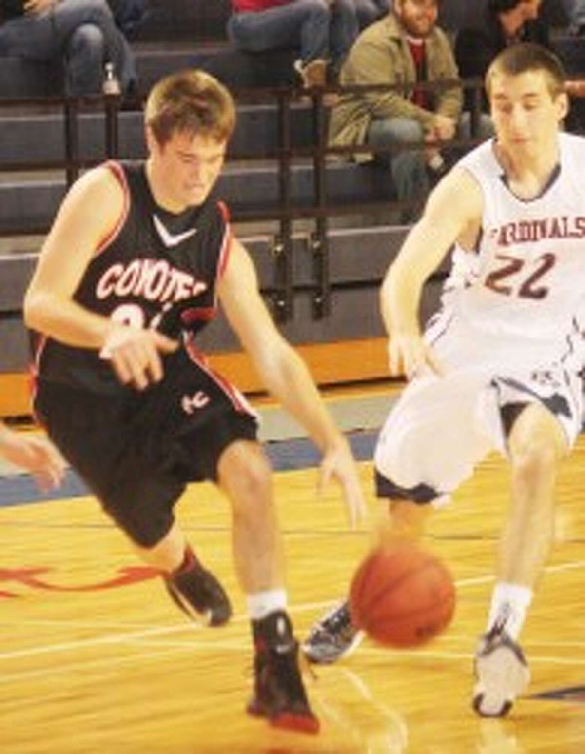 DRIVING: Big Rapids' Tyler Pellerito defends Reed City's Chad Samuels during Thursday's high school basketball action. (Pioneer photo/John Raffel)