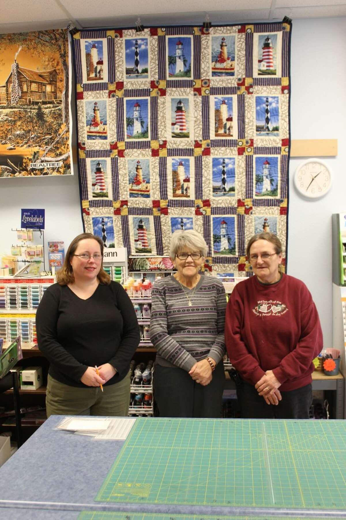 QUILTERS: Crossroads Quilt Shop sells material, yarn, books and other items for quilters. Pictured (from left) is Kim Venema, owner Patsy Blue and Shirleen Vanover. Not pictured is Denise Archer. (Herald Review photos/Sarah Neubecker)
