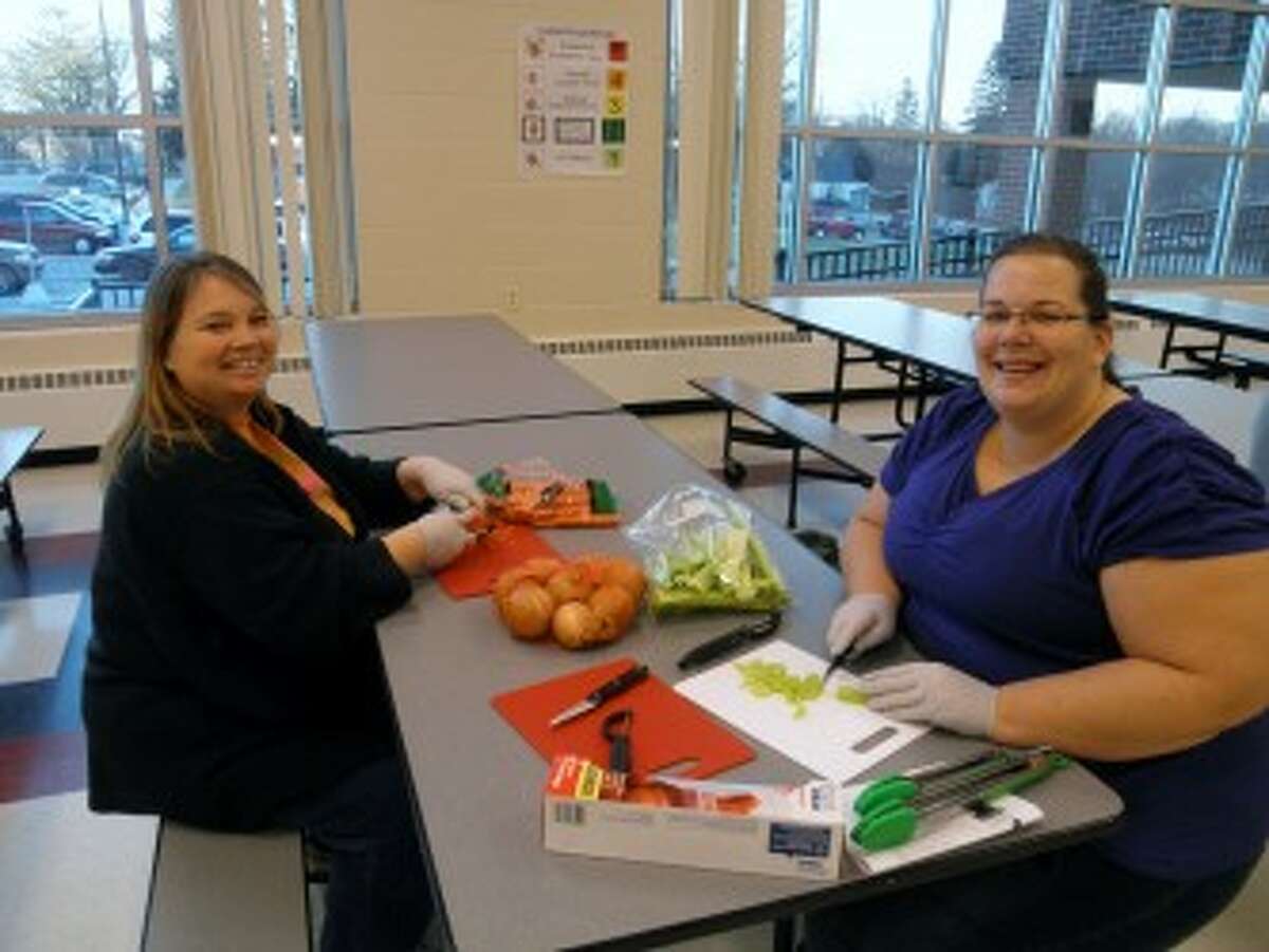HEALTHY EATING: Parents chop up vegetables to take home for a soup recipe at a “meals on a budget” parent workshop at G.T. Norman. A dietitian from Spectrum Health Reed City Hospital led the workshop, which was sponsored by Blue Cross Blue Shield of Michigan.