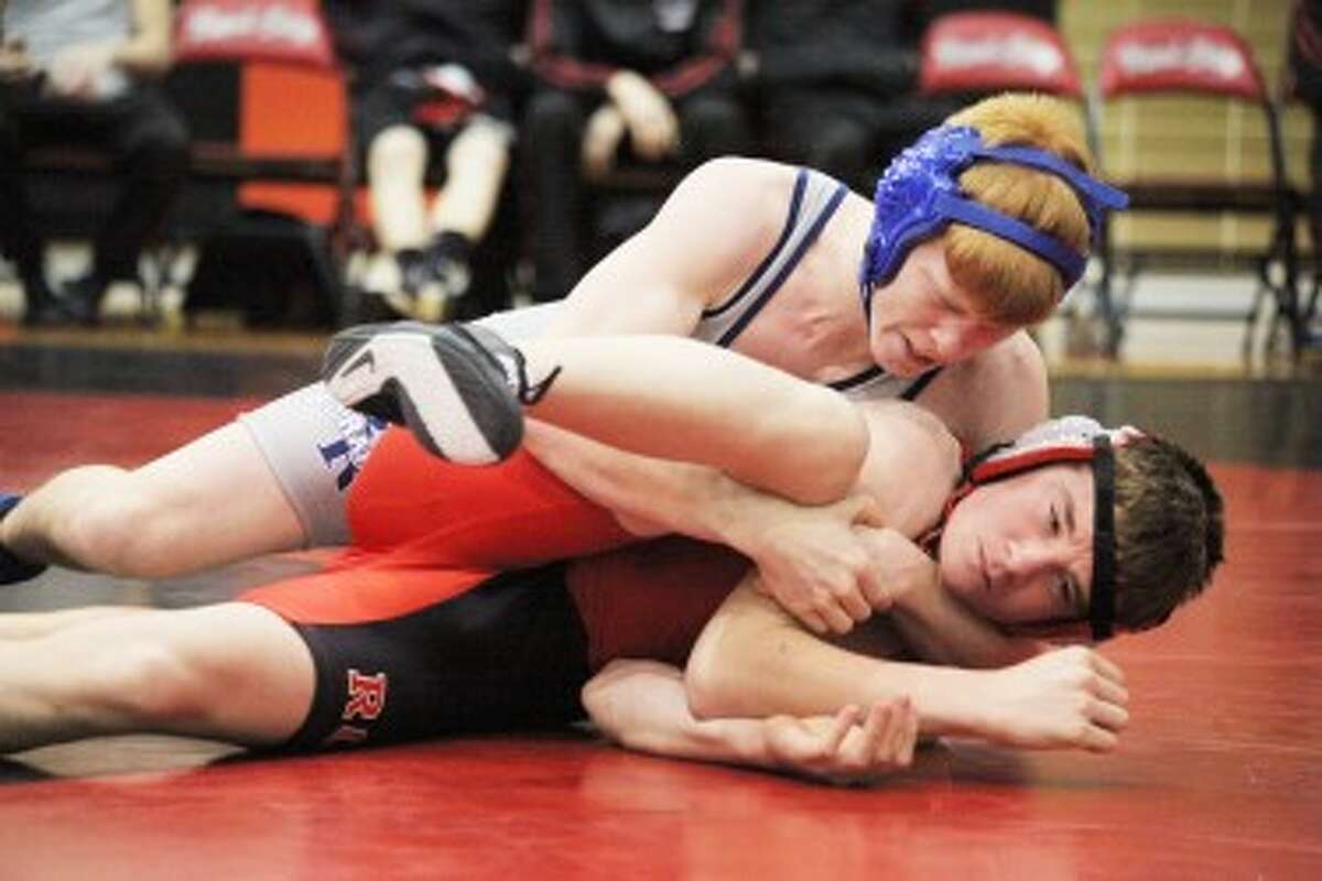 MAKING A MOVE: Big Rapids' Patrick Kettner (top) tries to turn Reed City's Troy Giese in their wrestling match Wednesday. Giese won the match by pin. (Pioneer photo/Bob Allan)