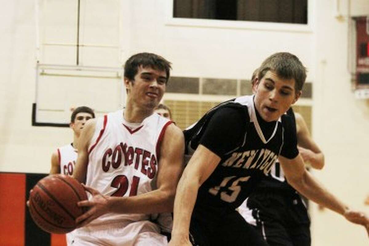 AND ONE: Reed City's Chad Samuels (left) is fouled on his way to the basket against Newaygo on Monday in boys basketball action. (Pioneer photo/Bob Allan)