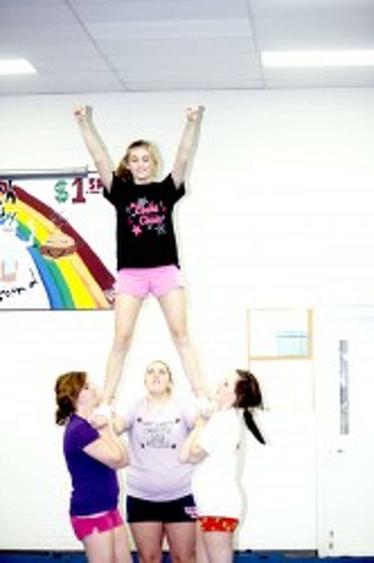 FOCUS: Evart cheerleaders focus on a mount during a recent practice. (File photo)