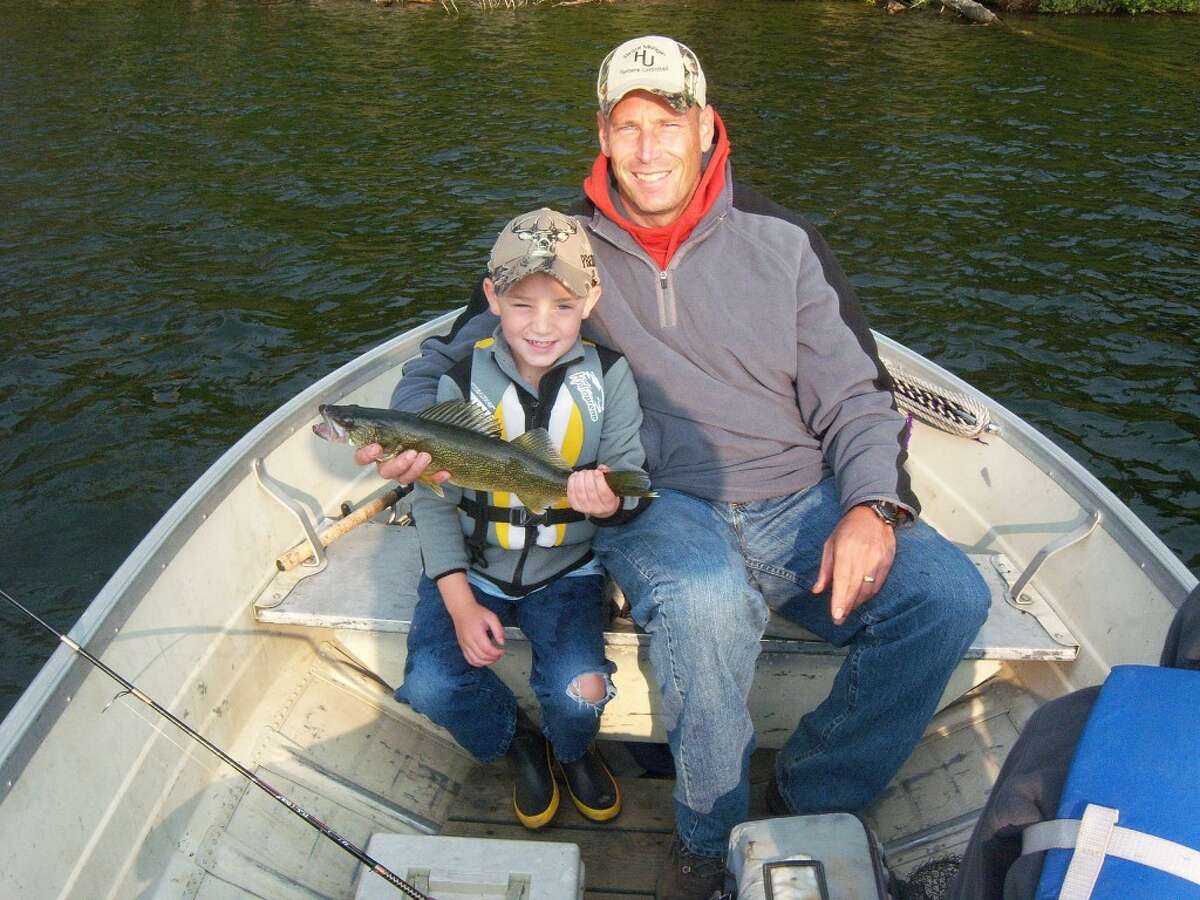 UP NORTH: Jay Wallace of Evart, and his son, Preston, at their Canada fishing trip last summer. (Courtesy photo)