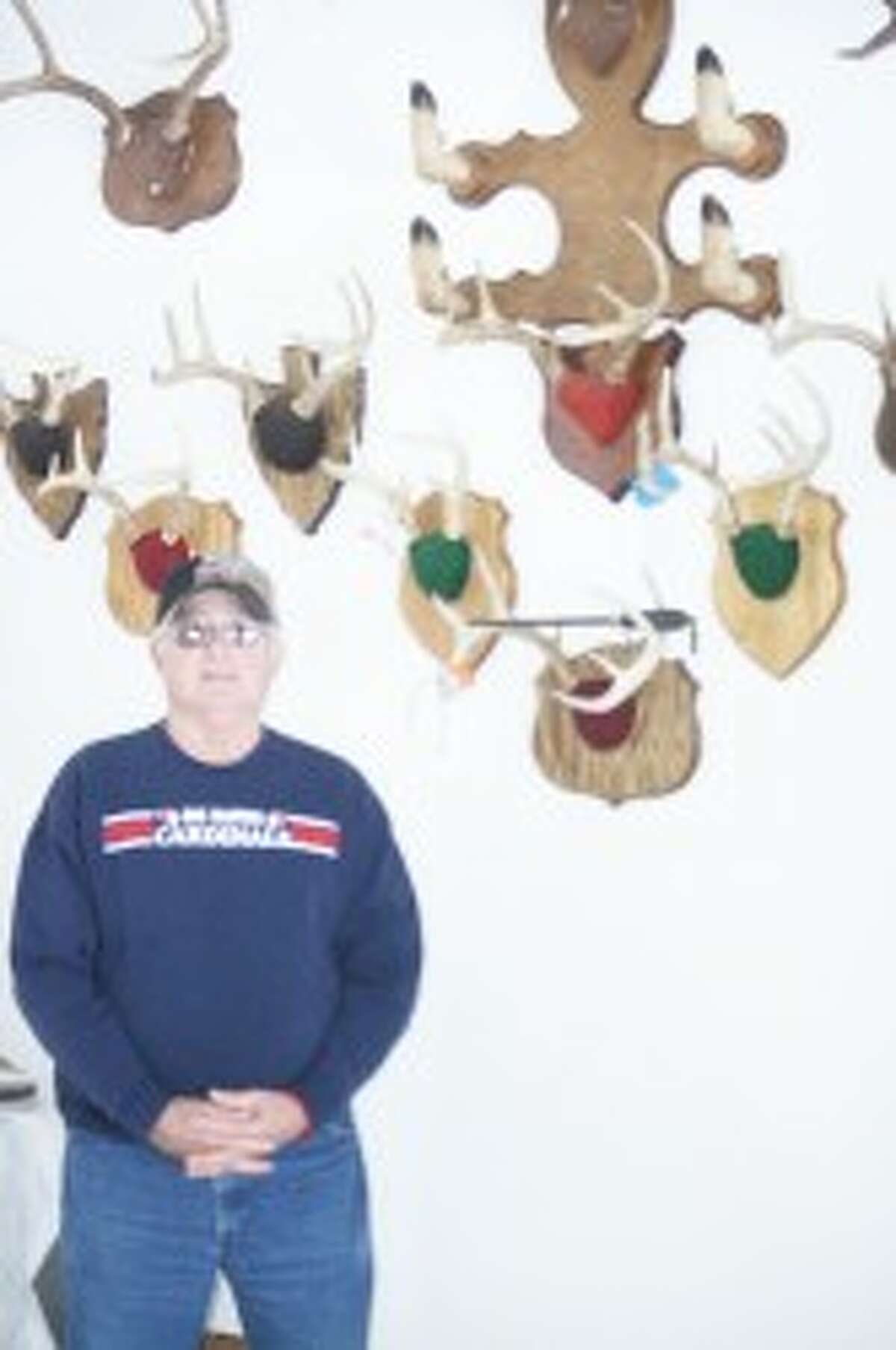 Trophies: Dave Robinson, with his many hunting trophies. (John Raffel/Herald Review photo)